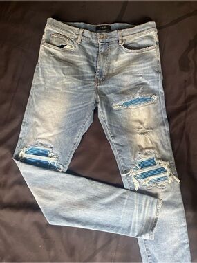 AMIRI Light Blue Distressed Skinny Jeans with Blue Patch Accents